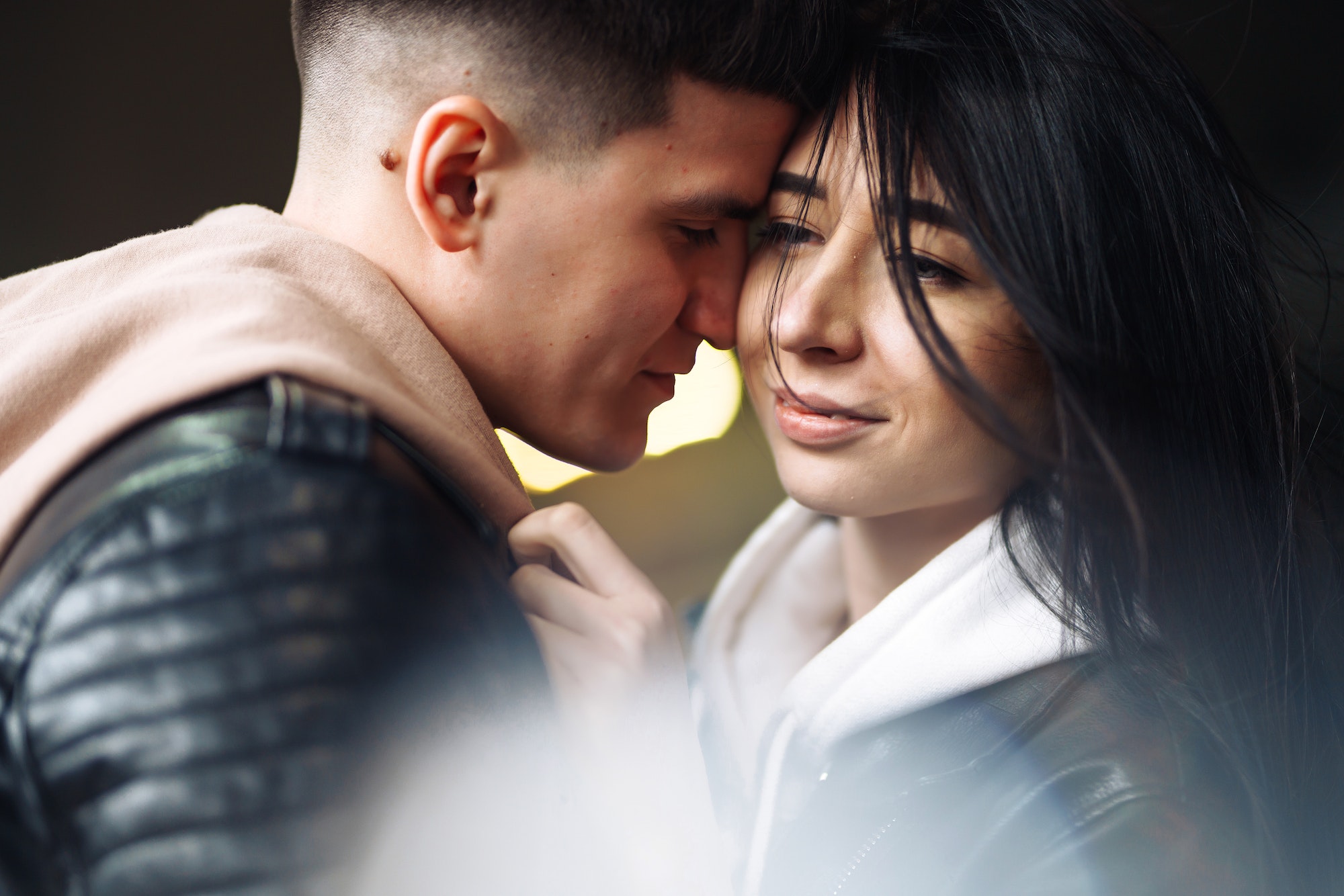 Young couple in love hug each other and kisses in underground crossing. Love story.
